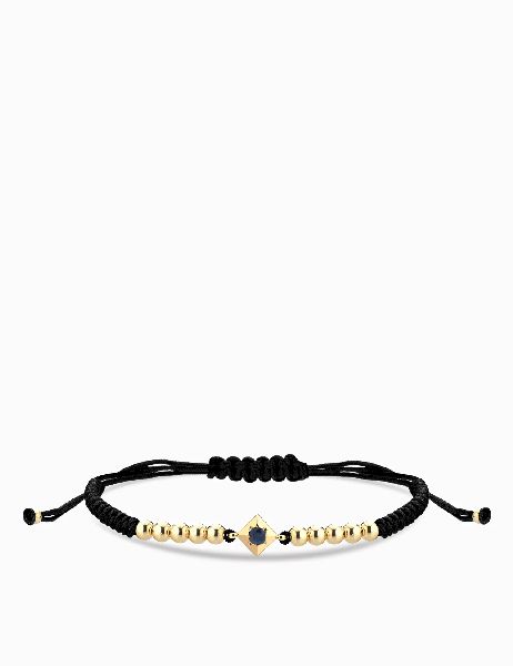 bracciale laccio in oro giallo con punto luce zaffiro centrale