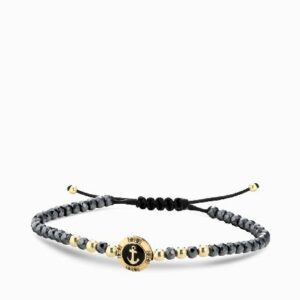 bracciale a monetina in oro giallo con diamanti neri e ancora ed ematite grigia