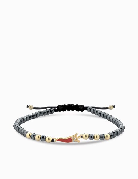 bracciale in oro giallo con corno smaltato rosso ematite e diamanti