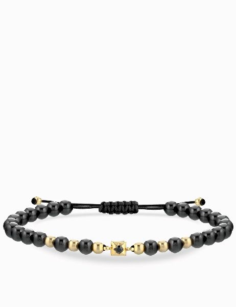 bracciale laccio con ceramica in oro giallo con punto luce centrale di diamante nero